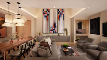 Ein modernes Wohnzimmer mit einem Holzesstisch, Sofas und einem schwarzen Couchtisch. Zwei Pendelleuchten, ein großes abstraktes Gemälde und eine Küche im Hintergrund.