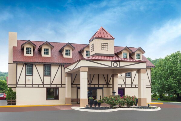 A two-story building with a prominent tower and a covered entrance. - Baymont by Wyndham Helen (Helen)