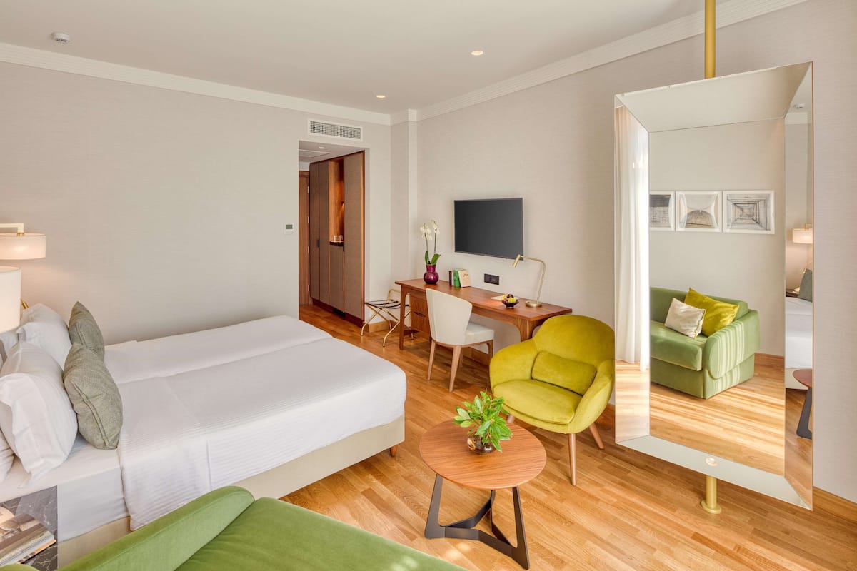 Premium driepersoonskamer, uitzicht op zee | Luxe beddengoed, een minibar, een kluis op de kamer, een bureau