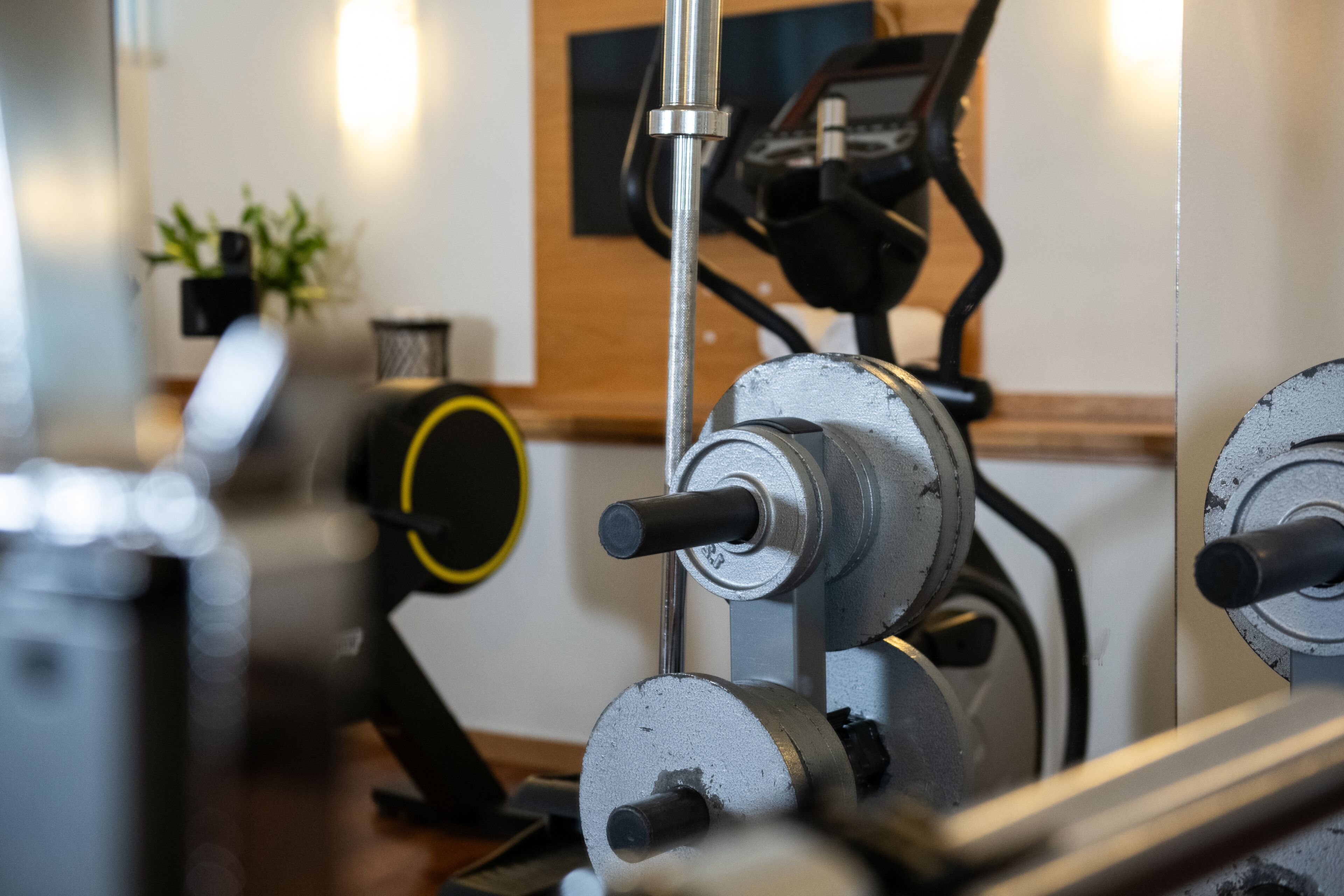 A gym with exercise equipment, including a stationary bike and a weight bench.