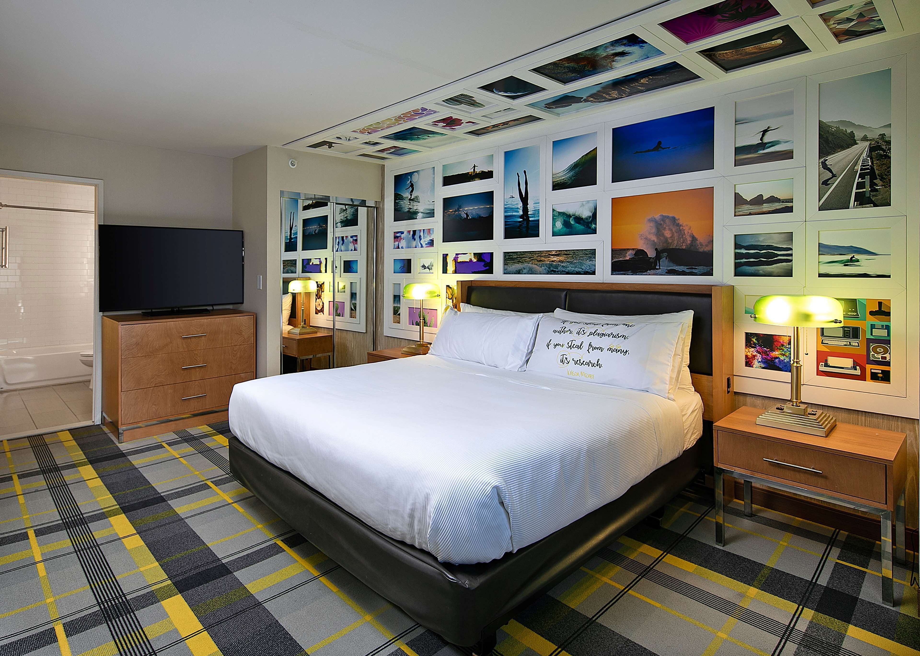 A hotel room with a bed, a TV, a desk, and a nightstand.