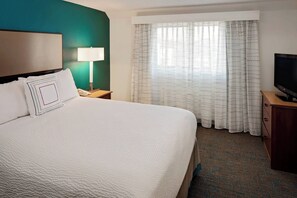 Hypo-allergenic bedding, desk, laptop workspace, blackout drapes