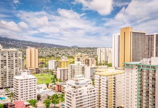 A high-rise urban area with multiple buildings, some with balconies and others with flat roofs.