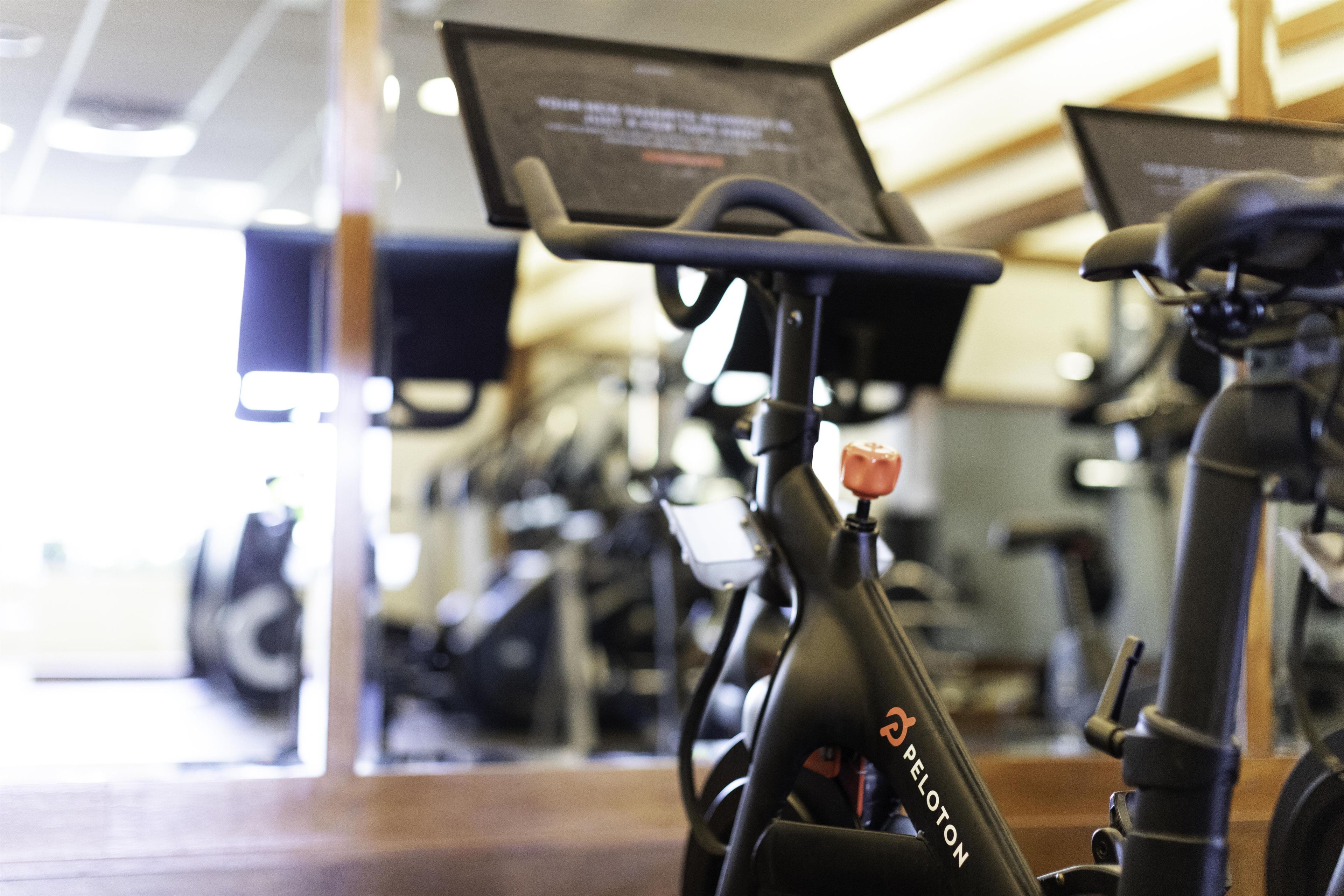 A stationary bike with a digital display and a water bottle attached.