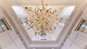 A grand hall with a high ceiling adorned with floral decorations and classical architectural details. - The Davenport (Dublin)