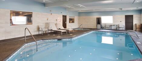 A swimming pool with a 3 FT 09" depth marker, tiled walls, and a ceiling with recessed lighting.