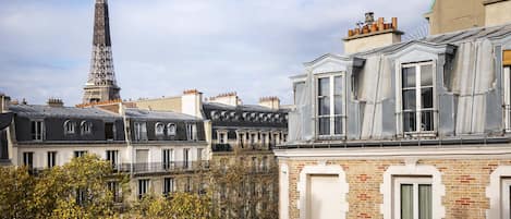 A view of Parisian buildings with the Eiffel Tower in the background.