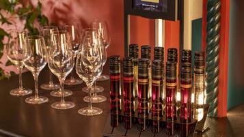 A wine tasting setup with multiple wine glasses and bottles on a counter.