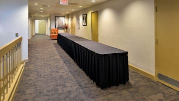 Meetings and events take place in this well-appointed corridor with a long table and comfortable seating.
