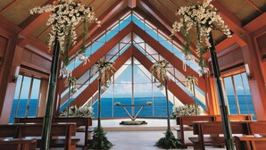 A chapel with wooden beams, large windows, and floral arrangements. - Shangri-La Mactan, Cebu (Lapu-Lapu)