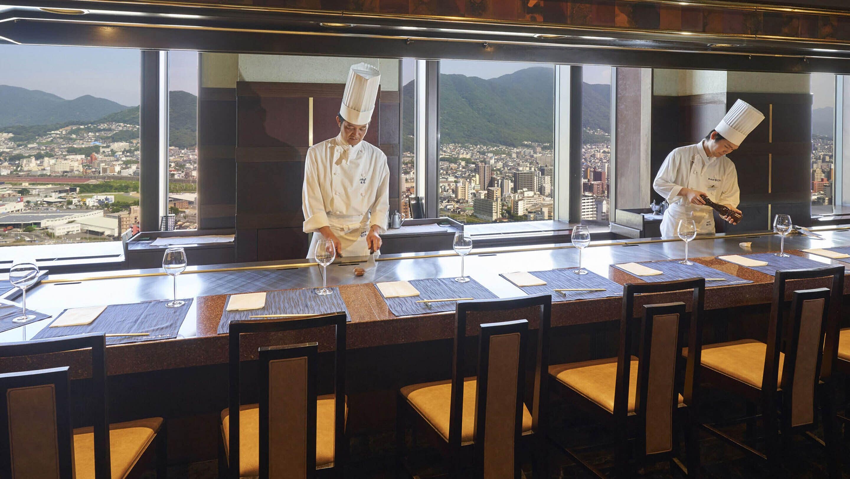A high-rise restaurant with a panoramic city view.
