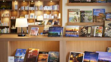 A bookstore with books on display and a lamp on the counter.