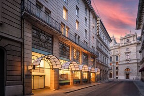 A hotel with a classic facade, multiple balconies, and a prominent sign. - K+K Hotel Opera Budapest (Budapest)