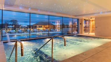 Relax by the pool with a view of the surrounding landscape through large windows.