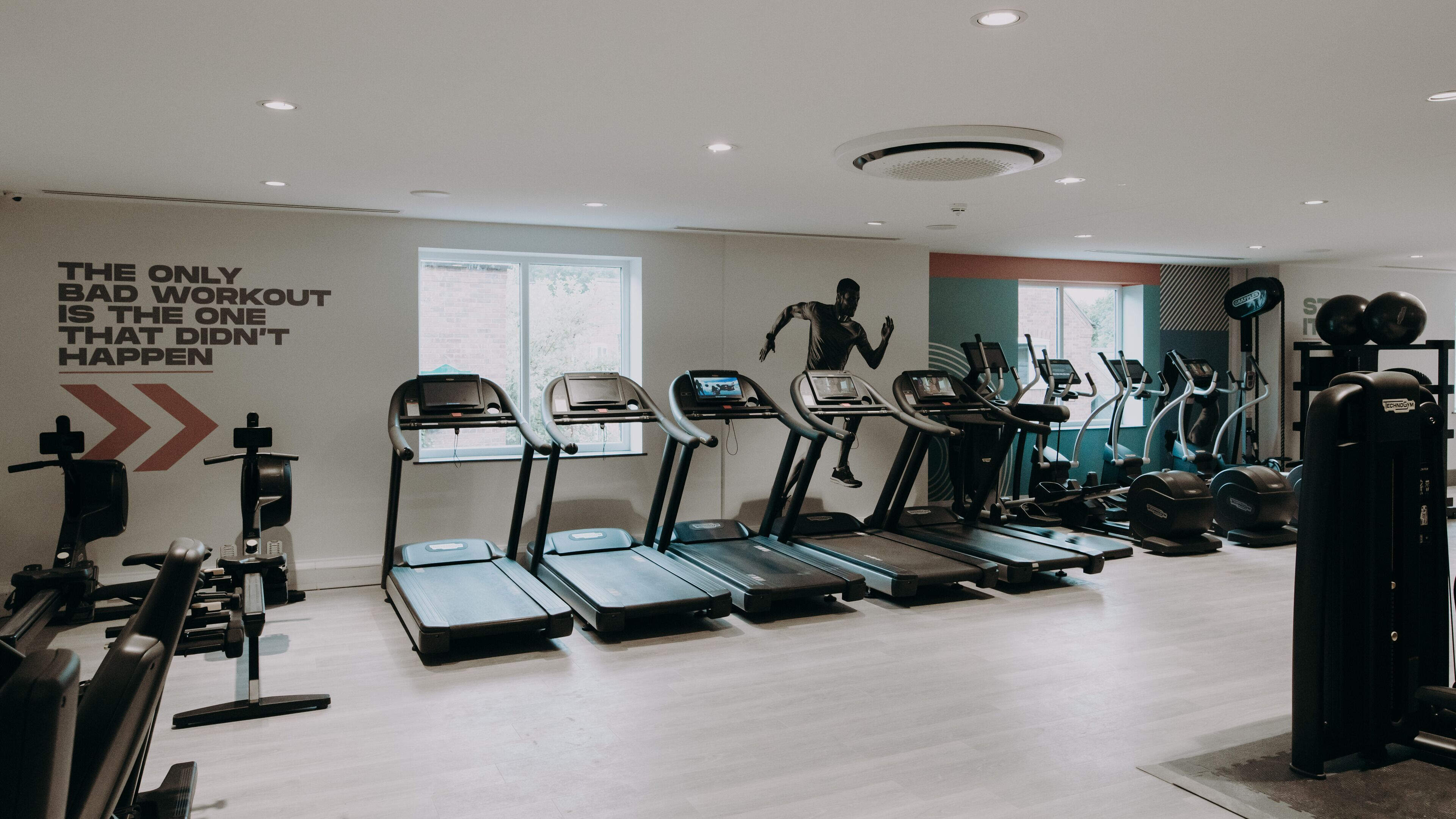 A gym with treadmills, ellipticals, and weight machines.