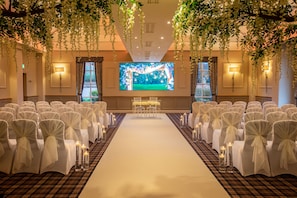 Intimate wedding ceremonies take place in this elegant space, surrounded by lush greenery and beautiful floral arrangements.