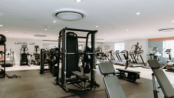 A gym with various exercise equipment, including treadmills and weight machines.