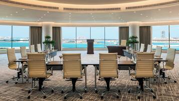 A conference room with a panoramic view of the city and the sea.