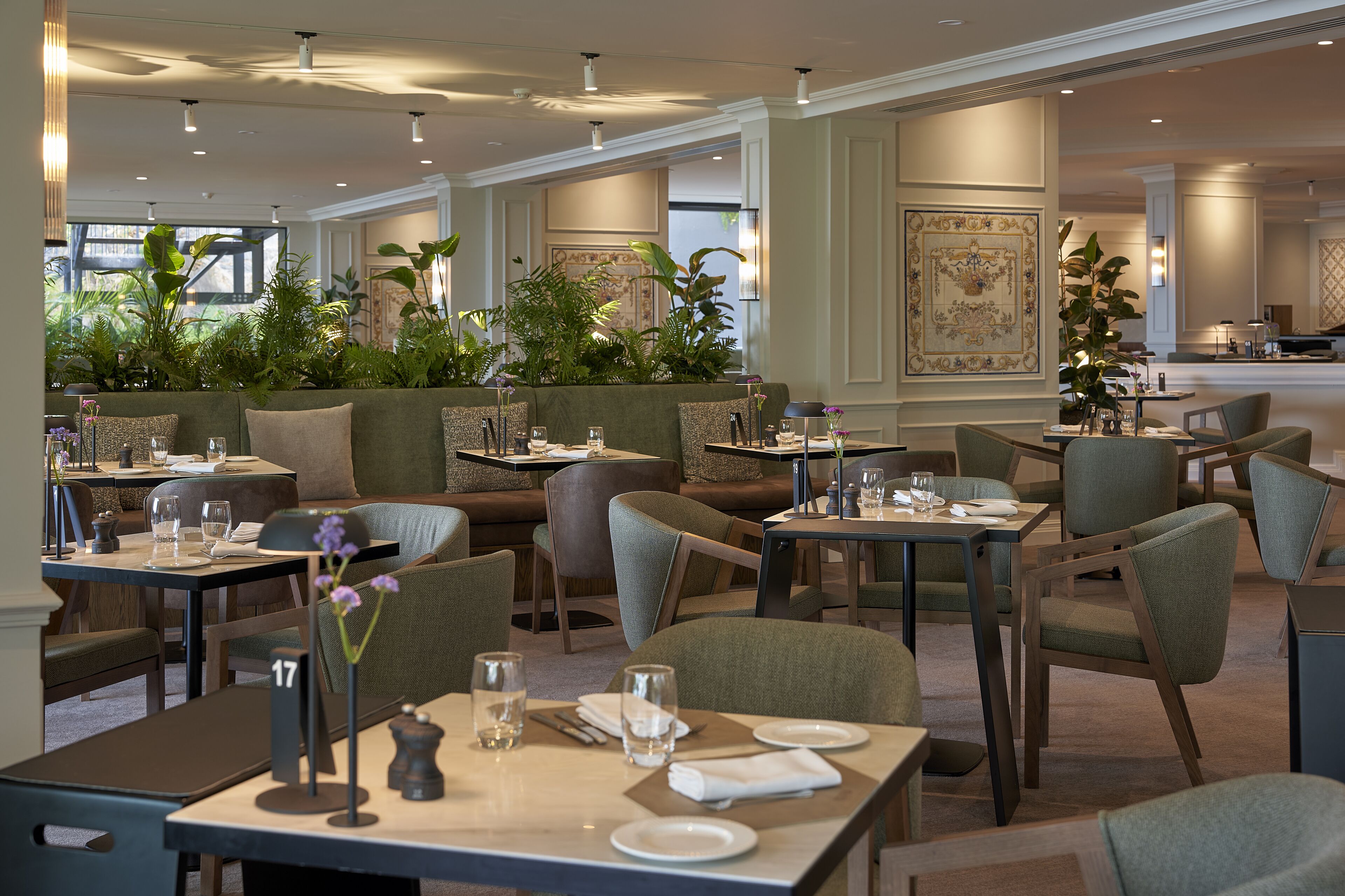 A restaurant with multiple seating areas, including booths and tables, with a view of the outdoors.