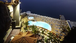 A resort with a large pool, beach area, and a high vantage point overlooking the sea. - The Cliff Bay, by PortoBay (Funchal)