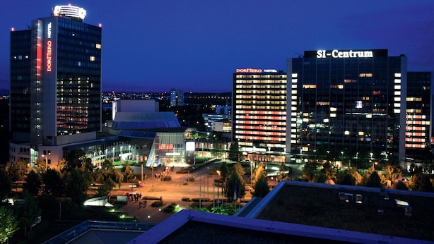 A cityscape at dusk with prominent buildings including the DORUMERO HOTEL and SI-Centrum. - DORMERO Hotel Stuttgart (Stuttgart)