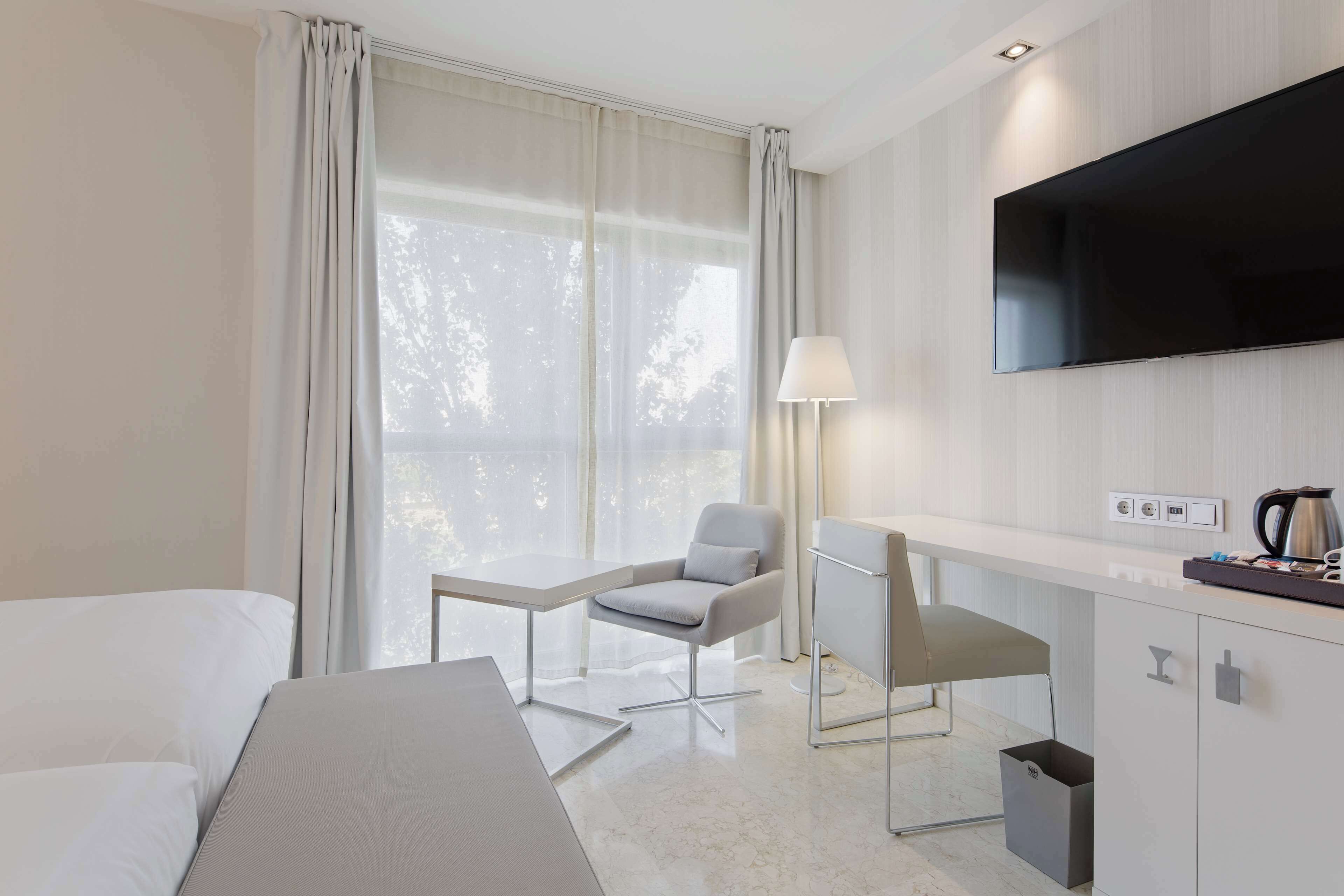 minibar, desk, blackout curtains, iron/ironing board