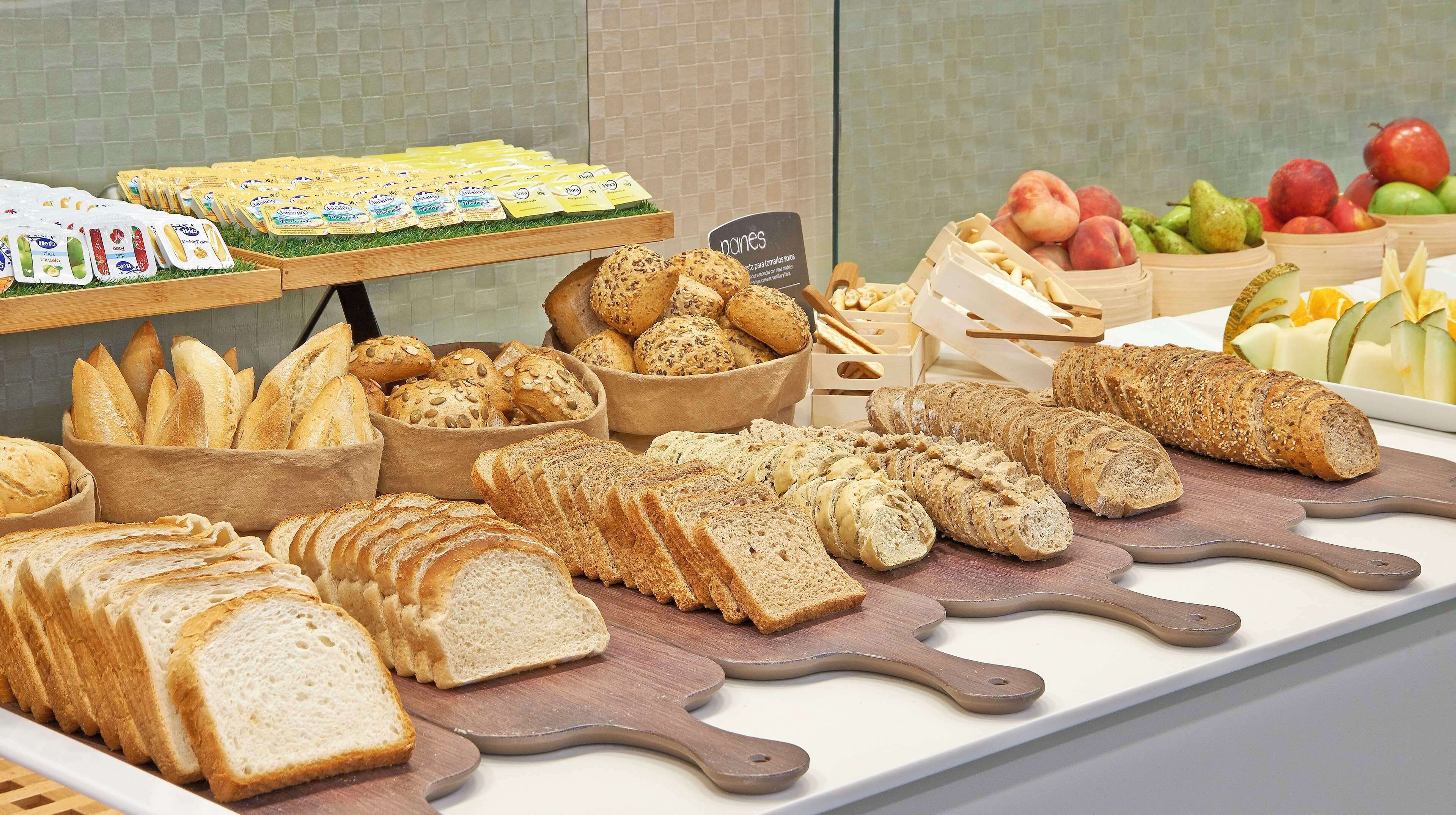 A variety of breads and pastries displayed on a counter.