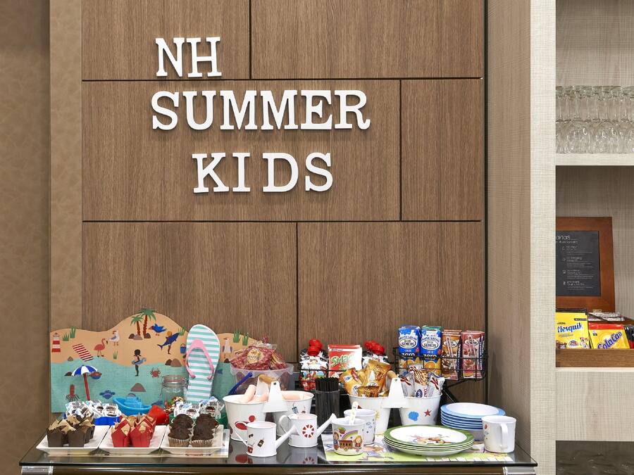 A display for NH Summer Kids with various food items and a beach-themed backdrop.