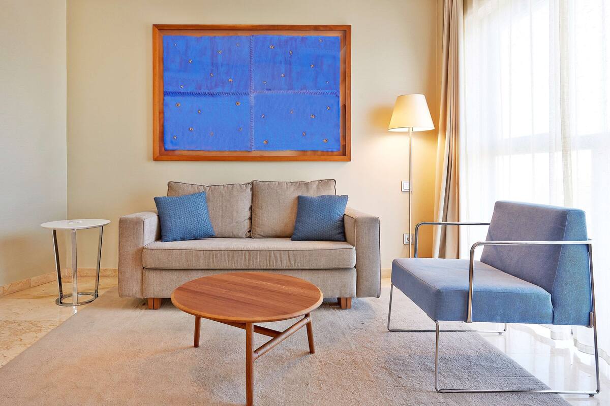 family room, city view | minibar, desk, blackout curtains, iron/ironing board