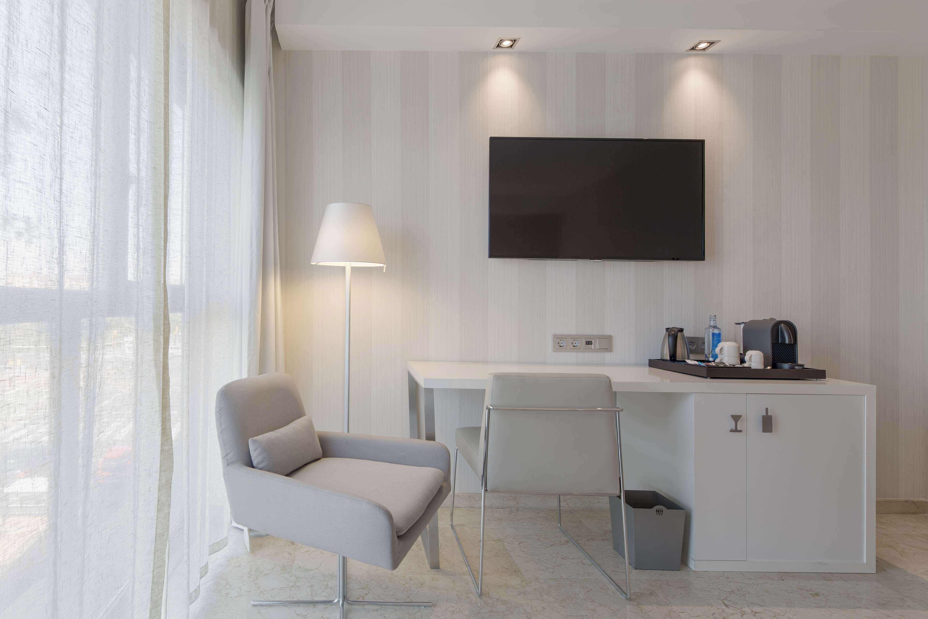 minibar, desk, blackout curtains, iron/ironing board