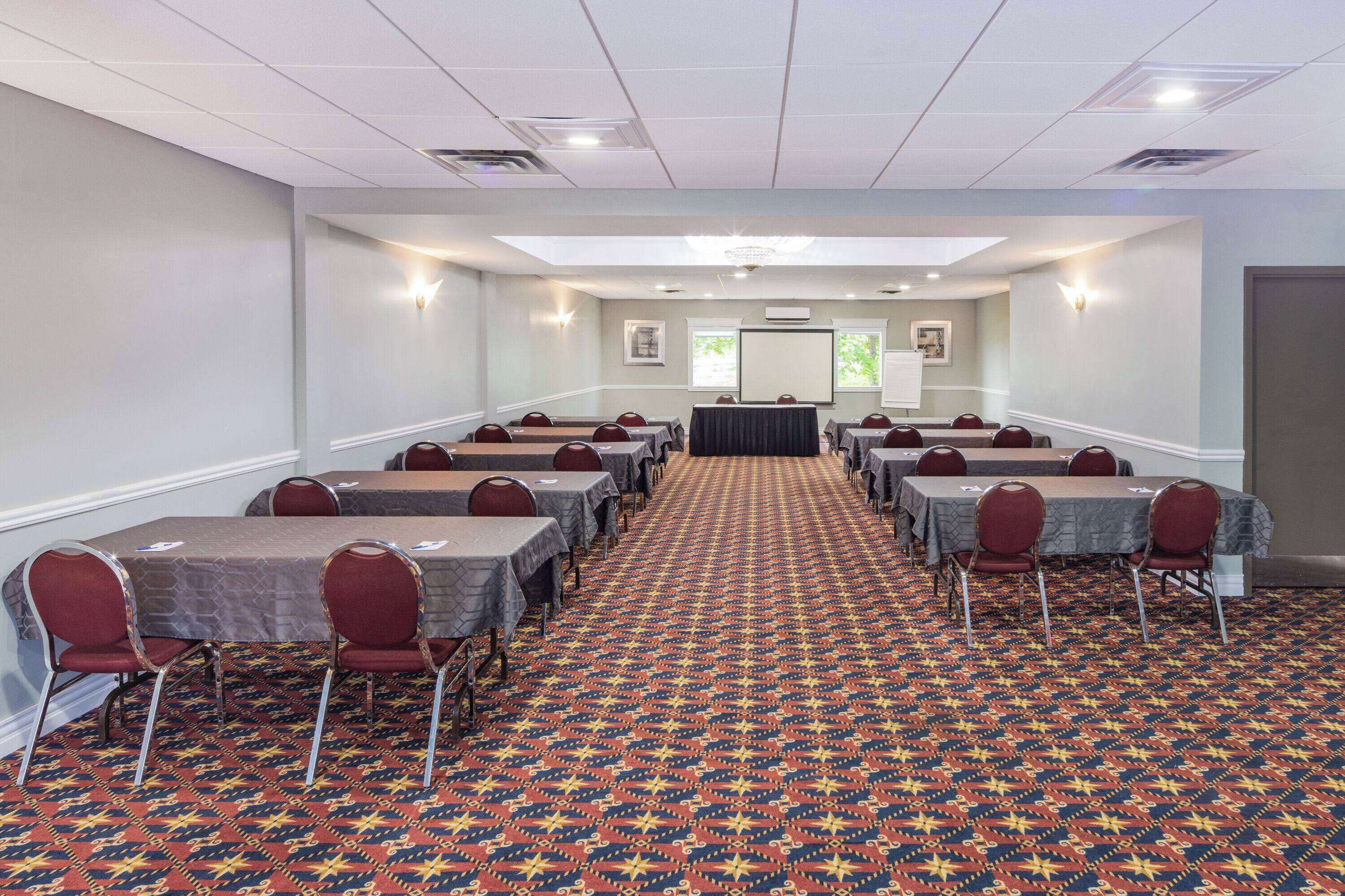 A conference room with tables and chairs arranged for meetings.