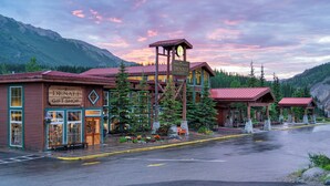 A rustic lodge with a gift shop, wooden architecture, and a clock tower.