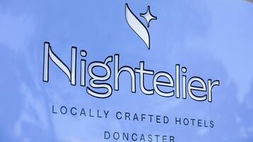 A sign for 'Nightelier' with the text 'Locally Crafted Hotels' and 'Doncaster'.