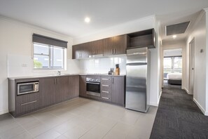 Two Bedroom Apartment | Private kitchen | Fridge, microwave, stovetop, electric kettle