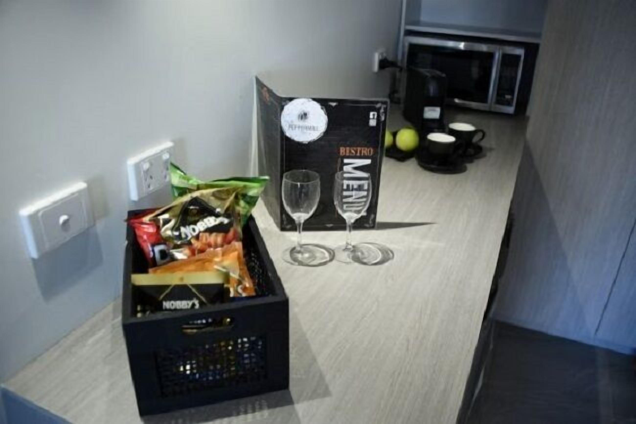 A kitchenette with a black box labeled "NOBBY'S" and a "BISTRO MENU" sign.