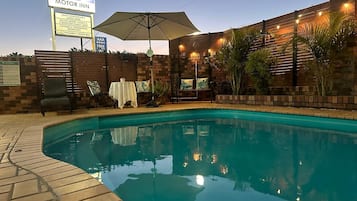 Seasonal outdoor pool, open 9:00 AM to 9:00 PM, pool umbrellas