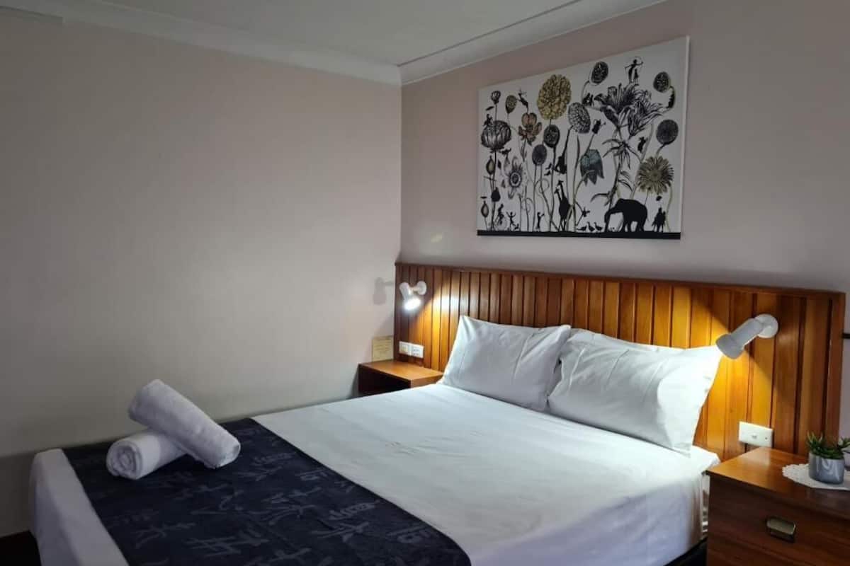 Premium bedding, pillow-top beds, desk, laptop workspace