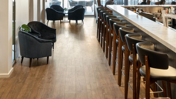 A modern bar area with a long counter, black bar stools, and a unique chandelier. - Quality Hotel Wangaratta Gateway (Wangaratta)