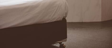 A room with a bed, a window, and a radiator.