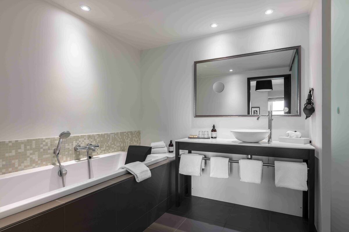 suite, 1 king bed with sofa bed, non smoking | bathroom | shower, eco-friendly toiletries, hair dryer, towels