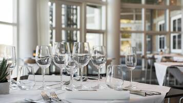 A table set with multiple wine glasses and cutlery, indicating a formal dining setting.