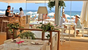 Un restaurante frente al mar, con mesas dispuestas para comer y vistas al océano.