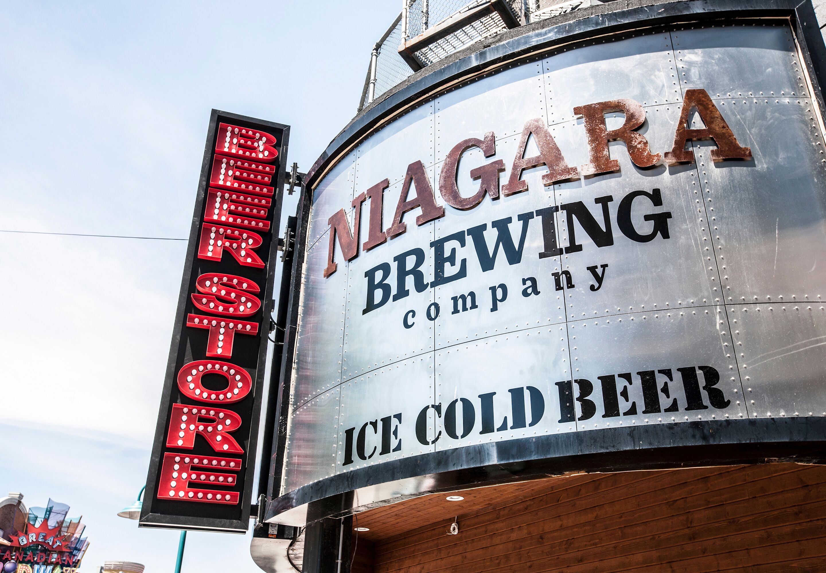 A large metal sign with the text "Niagara Brewing Company" and "Ice Cold Beer" on it.