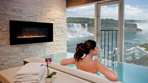 A woman relaxing in a bathtub with a view of a waterfall. - Sheraton Fallsview Hotel (Niagara Falls)