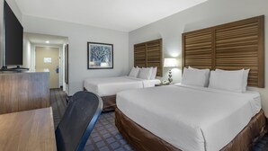 A hotel room with a large bed, two smaller beds, a desk, a TV, and a framed picture on the wall. - Best Western Fishers/Indianapolis Area (Fishers)