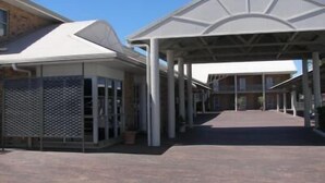 A covered entrance with a modern architectural design, featuring a central open space and a covered walkway leading to a building. - Gympie Muster Inn (Gympie)