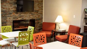 Cozy space with a fireplace, comfortable seating, and a flat-screen TV for social gatherings and relaxation.