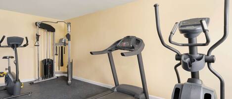 A gym with treadmills, a stationary bike, and a weight machine.