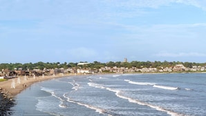 A coastal town with a beach, houses, and a church on a hill. - Days Inn by Wyndham Middletown/Newport Area (Middletown)
