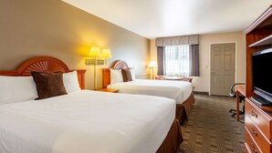 A hotel room with two beds, a TV, a desk, and a chair. - Americas Best Value Inn Burns (Burns)